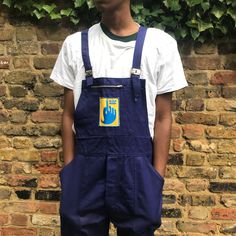 "Dark blue workwear cotton dungarees with an incredible blue and yellow logo on the main pocket. Deastock, marked size 48, medium. Made by heritage brand Lafodex. Large bib pocket and pen pocket, 2 hip pockets, 1 back pocket and 1 tool pocket. 2 buttons on each side at the hip. Adjustable straps with metal clips, button fly. 100% cotton. Waist 40\" (101cm) Hips 42\" (107cm) Inside leg 33\" (84cm)  Rise 12\" (28cm) Front (rise to top) 23.5\" (60cm)" Blue And Yellow Logo, Cotton Dungaree, French Workwear, Yellow Logo, Boiler Suit, Workwear Jacket, Vogue Magazine, Heritage Brands, Blue And Yellow