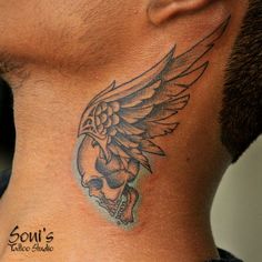 a man with a skull and wings tattoo on his neck