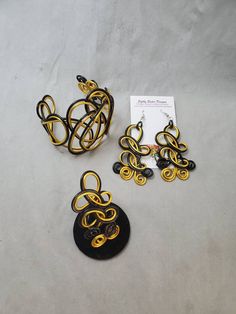 "Black and gold colored jewelry set, this beautiful cuff bracelet, ring, and matching earrings are a statement set that will get plenty of compliments. Made of non-tarnish, lightweight aluminum wire. The cuff is adjustable and the earrings are 3\" long with surgical steel ear wires. Be sure to choose your ring size. I want my customers to be happy, so please look carefully at the photos, and feel free to ask any questions. I post new items as soon as they are created so please come back and visi Elegant Yellow Metal Jewelry, Formal Yellow Metal Jewelry, Yellow Metal Party Jewelry, Elegant Adjustable Yellow Cuff Bracelet, Adjustable Jewelry For Evening, Adjustable Gold Jewelry For Evening, Gold Adjustable Jewelry For Evening, Unique Yellow Jewelry With Matching Earrings, Elegant Yellow Cuff Bracelet As Gift