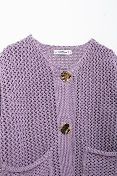 Say hello to cozy charm with the Lilac Ivy Mesh Knit Cardigan. Crafted in a soft lilac hue, this open-knit cardigan features oversized gold-tone buttons for a touch of vintage glamour. The relaxed, boxy fit makes it perfect for easy layering, whether you’re keeping it casual at home or out for a weekend coffee run. Front pockets add extra detail, perfect for keeping your essentials close. With its unique mesh texture, the Lilac Ivy Cardigan is your new favorite piece for transitional weather. Specs: Material: Polyester Spring Purple Cardigan With Button Closure, Trendy Purple Knitted Cardigan, Purple Cotton Cardigan, Purple Knitted Long Sleeve Cardigan, Oversized Purple Knit Cardigan, Purple Winter Cardigan With Button Closure, Purple Button-up Cotton Outerwear, Affordable Purple Button-up Cardigan, Winter Street