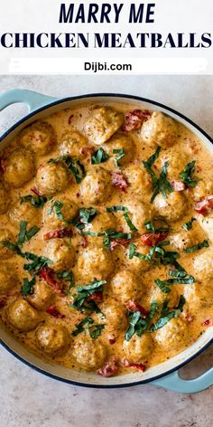 chicken meatballs with spinach and tomatoes in a blue pot on a white table