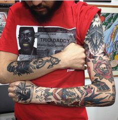 a man with many tattoos on his arms