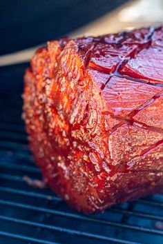 a piece of meat that is on top of a bbq grill with ketchup