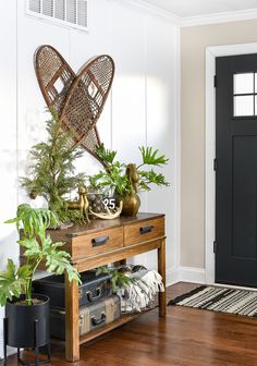 the entryway is decorated with greenery and other things to decorate on top of it