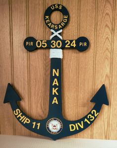 a wooden sign with an anchor on it