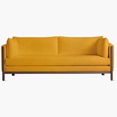 a yellow couch sitting on top of a white floor