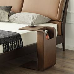 a bed with a wooden headboard and foot board on it's end table