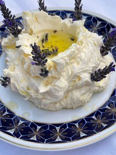 a plate topped with whipped cream and lavenders