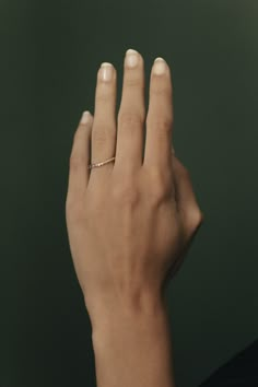 a woman's hand with a ring on it