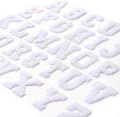 the letters and numbers are made out of toilet paper, which has been cut into small pieces