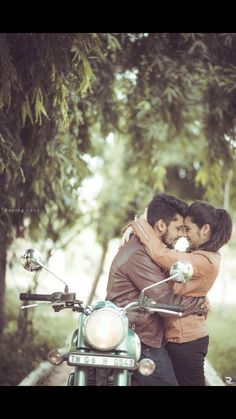 two people hugging each other on a motorcycle