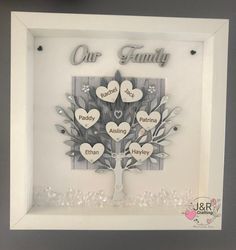 a family tree with two hearts hanging from it's sides in a white frame