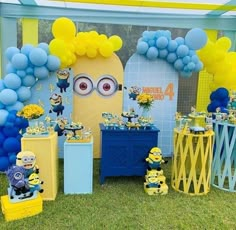 a party setup with balloons, decorations and minion figures on the grass at a despicable birthday party