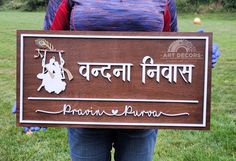 a person standing in the grass holding a sign