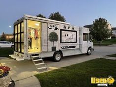 a mobile home is parked on the side of the road with stairs leading up to it