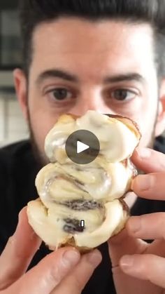 a man holding up a doughnut in front of his face