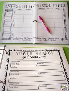 an open planner with a pink pen on top