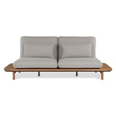 a couch with two pillows sitting on it's back end and one arm folded