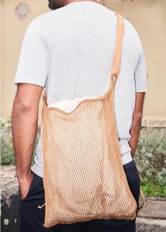 a man carrying a brown bag on his back with no shoes in front of him