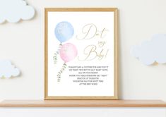 a baby shower print with balloons and greenery is displayed on a shelf next to clouds