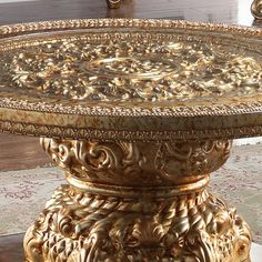 an ornately decorated table with gold paint on it's top and bottom edge