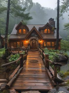 a wooden bridge leading to a log cabin in the woods with lights on it's windows