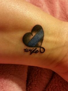 a small blue and black heart tattoo on the ankle that says,'hope '