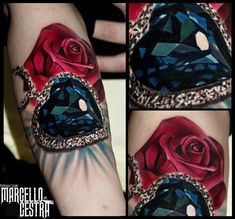 some tattoos on someone's arm with red roses and blue jewels in them,