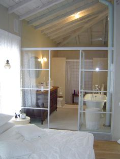 a bathroom with a tub, sink and toilet in it's own room that is open to the outside