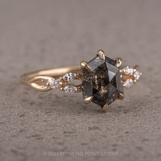 a black diamond ring with white diamonds on it