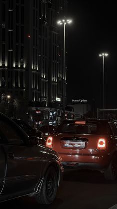 cars are parked on the street at night