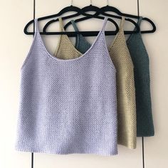 three women's tops hanging on a clothes rack