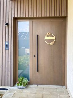 a brown door with a sign that says welcome to the house on it's side