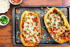 two stuffed sweet potatoes on a baking sheet with toppings next to the baked one