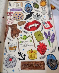 an open notebook with lots of stickers on it and some writing in the middle