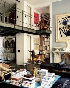 a living room filled with lots of furniture and books