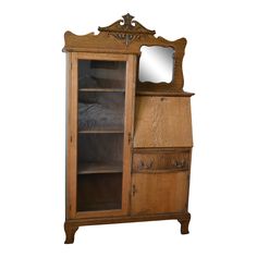 an old wooden cabinet with a mirror on top