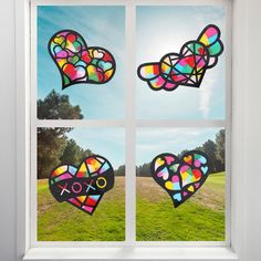 the window is decorated with stained glass hearts and xoxo signs in different colors