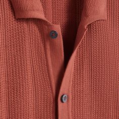 This short-sleeved polo sweater, crafted in 100% cotton yarn with a waffle rib texture, showcases a distinctive full button closure and flat knit trim on the placket, adding refinement and versatility to the classic polo style. Offering breathability, moisture-wicking, chemical-free comfort, and machine washability with low pilling, it ensures durability and year-round comfort. Short-sleeved Ribbed Polo Sweater For Fall, Fall Ribbed Short Sleeve Polo Sweater, Short Sleeve Textured Knit Polo Sweater For Fall, Casual Collared Ribbed Cardigan, Waffle Knit Tops For Workwear, Sweater Polo, Polo Style, Polo Sweater, Chemical Free