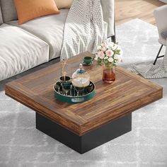 a coffee table with flowers on top in a living room