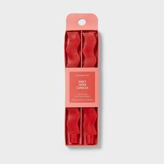 three pieces of red wax in a pink packaging