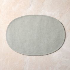 the oval rug is made from linen and has a light grey color scheme on it