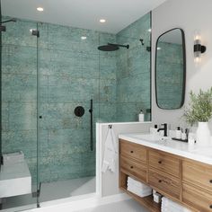 a bathroom with green tiles on the wall and wooden cabinetry, along with a walk in shower