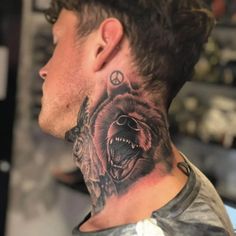 a man with a bear tattoo on his neck