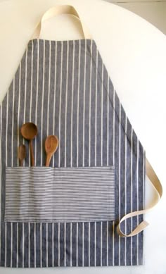 a striped apron with wooden spoons in it