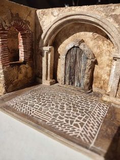 an intricately carved door in the middle of a stone building with arches and doorways