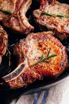 pork chops on a pan with rosemary garnish and text overlay that reads cast iron pork chops