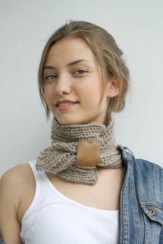 a woman wearing a knitted neck scarf