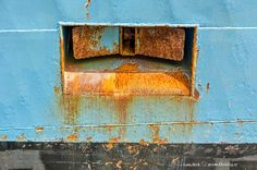 an old rusted metal structure with a window