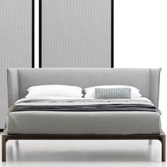 a modern bedroom with an upholstered bed and side tables